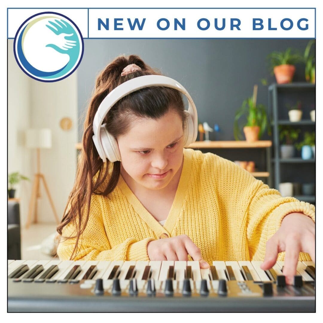 Person playing keyboard with headphones on.
