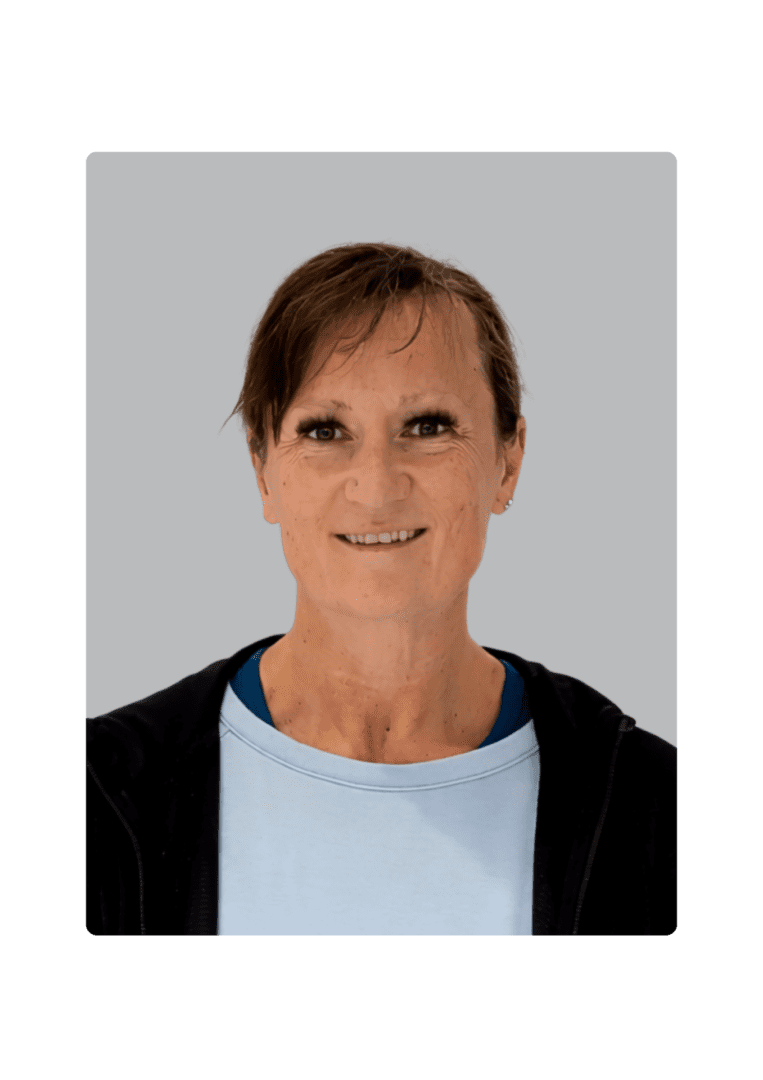 Smiling person in a light blue shirt.