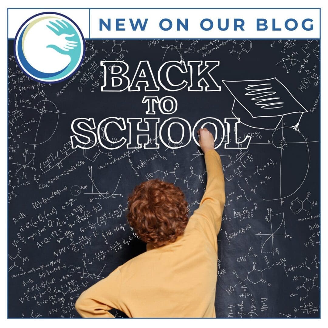 Child writing Back to School on chalkboard