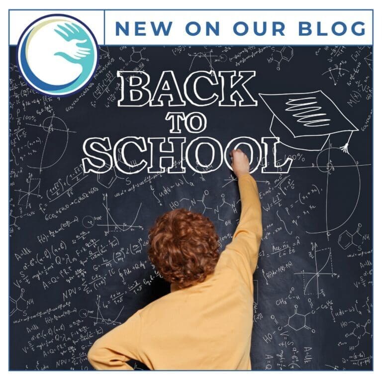 Child writing Back to School on chalkboard