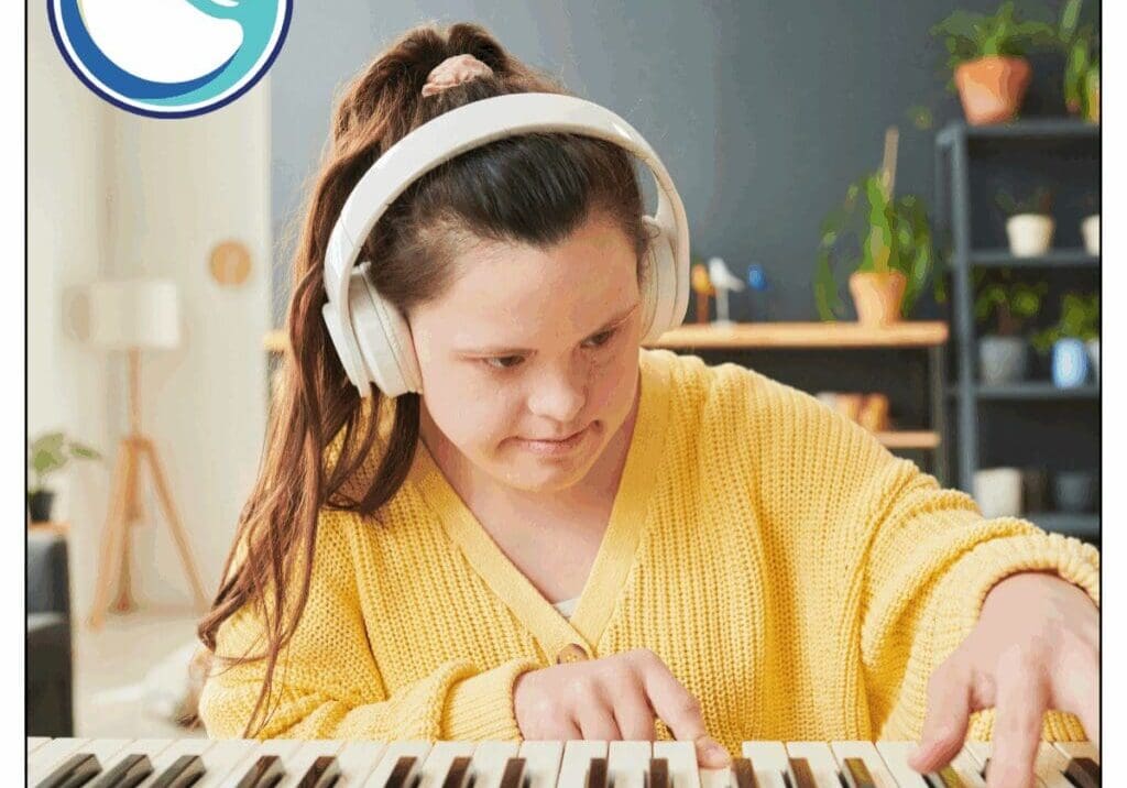 Person playing keyboard with headphones on.