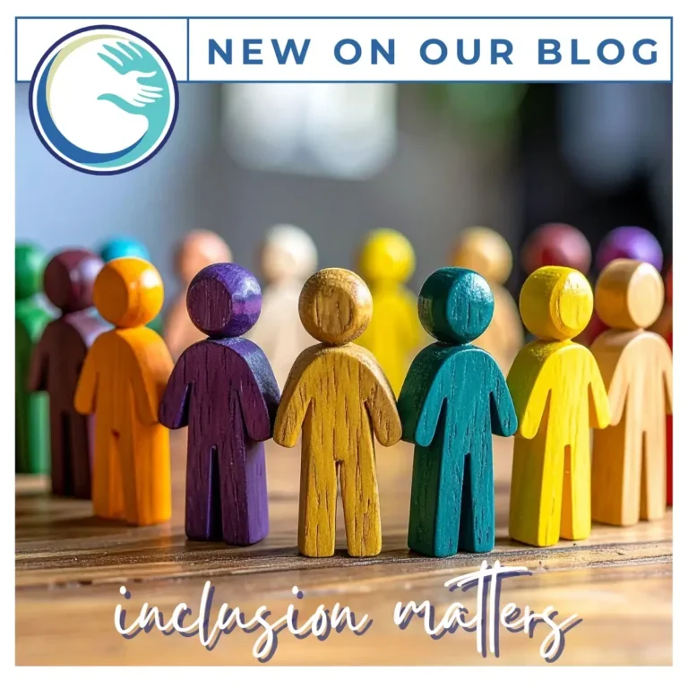 Row of painted wooden people under 'inclusion matters'.