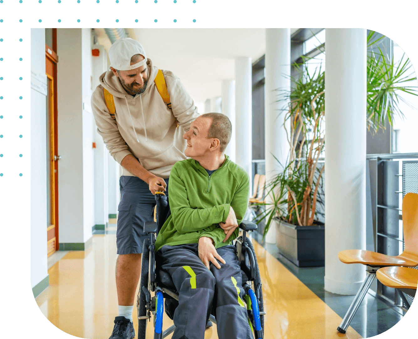 A man pushing another man in a wheelchair.